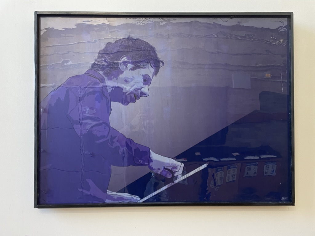 A printed and framed poster of an colorful illustrated poster of jazz pianist Chick Corea